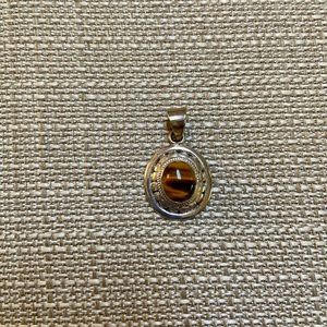 Sterling tiger’s eye pendant. 1-1/8 x 3/4 inches.